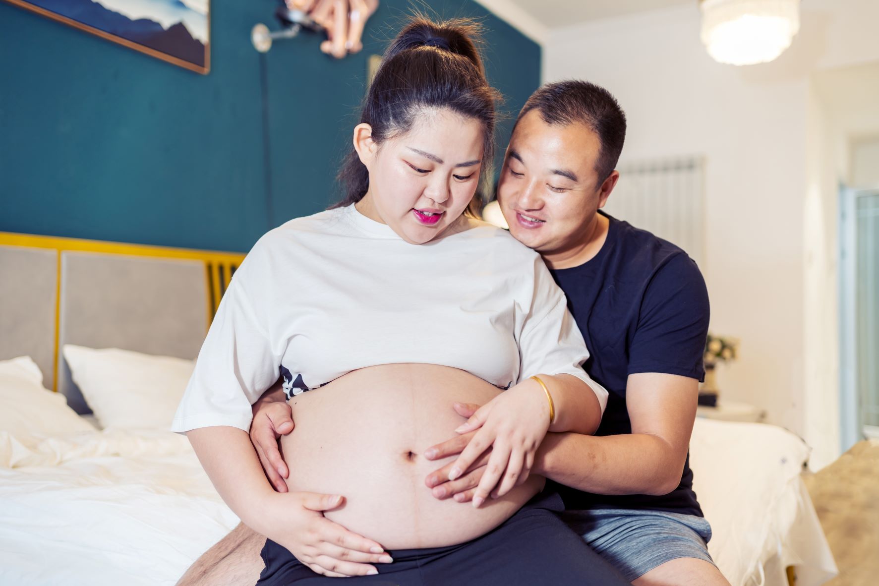Pregnant woman being held by male partner