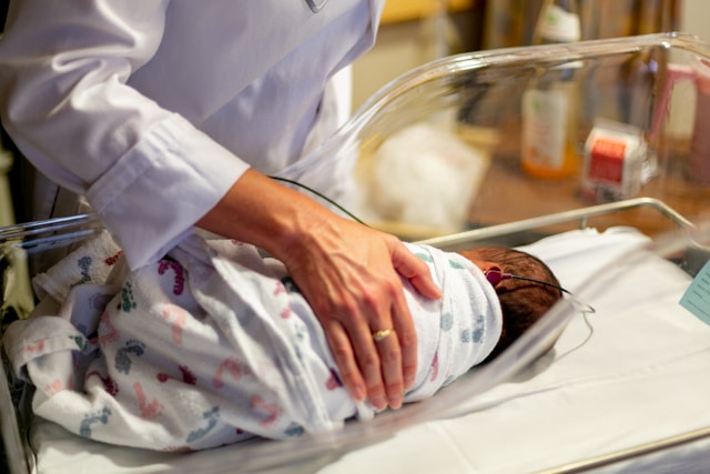 Baby in hospital cot